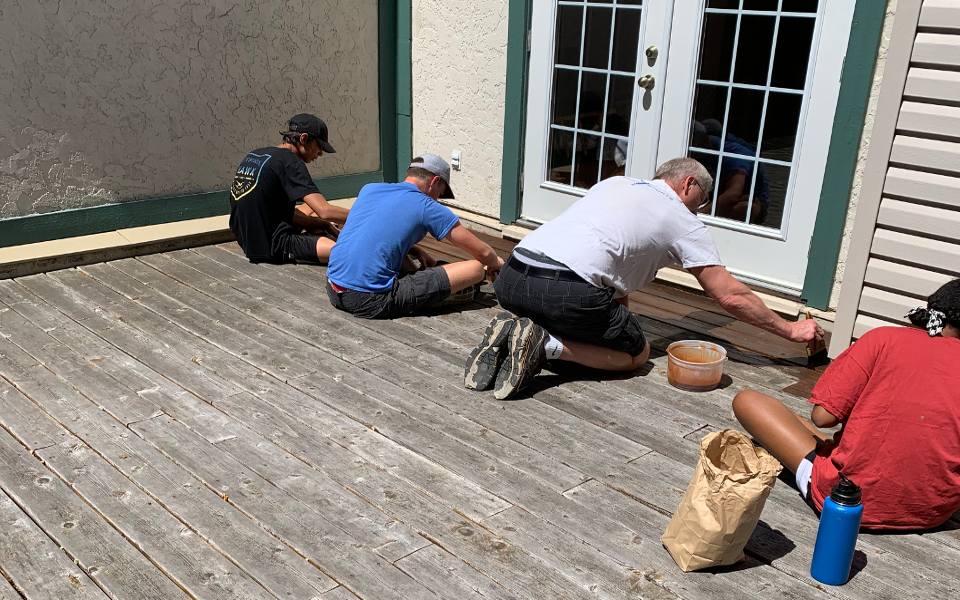 image of MBBF Youth helping to stain a deck