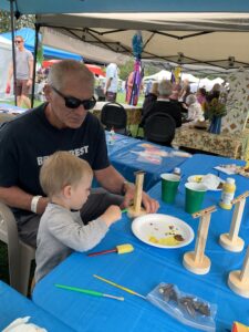 image of a child looking at crafts on table